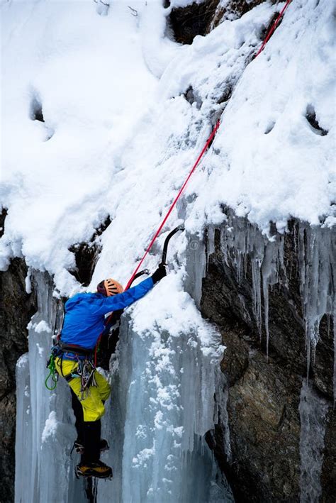 Brave Ice Climber Climbing A Iced Waterfall In Italian Alps Editorial