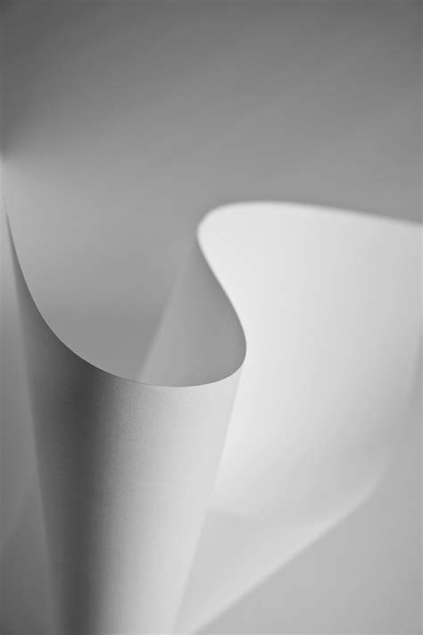 An Abstract Photo Of White Paper Folded In Two Different Directions