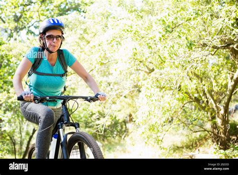 Mature Woman Riding Bike Stock Photo Alamy