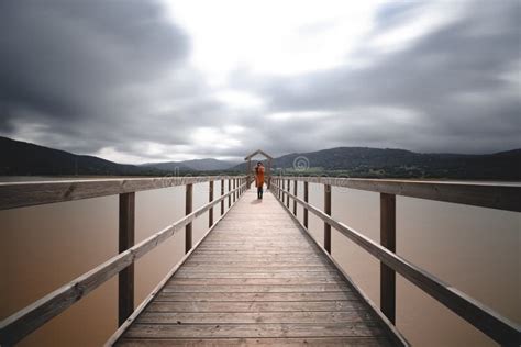 Wooden Bridge Across Lake On Cloudy Day Long Exposure Stock Image