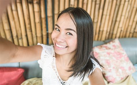 premium photo smiling thai girl selfie