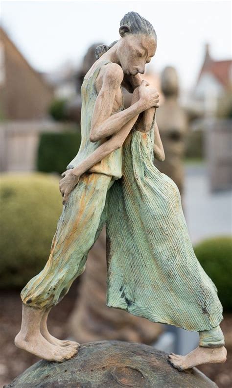 A Statue Of A Man Hugging A Woman