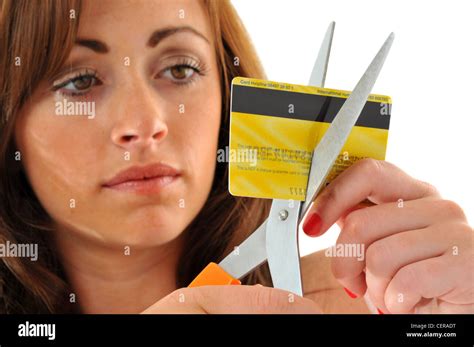 Credit Card Woman Cutting Up Her Credit Card With Scissors Stock Photo