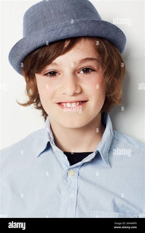 He Loves Hats Studio Shot Of A Young Preteen Boy In Casual Wear Stock