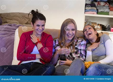 Laughing Young Girls Watching Tv Together Stock Photo Image Of