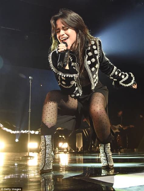 camila cabello sports daring sheer blouse with nude bodysuit and sparkling coat on first solo