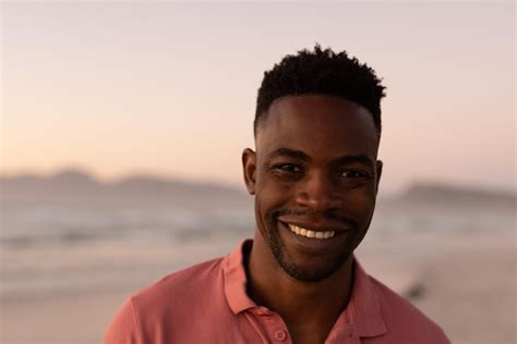 Premium Photo Close Up Portrait Of Smiling African American Young Man At Beach Against Clear