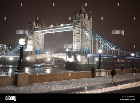 Night Scene Of Tower Bridge In London On A Cold Winter Evening As Snow