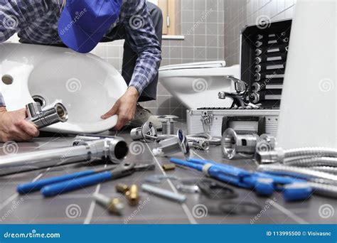 Plumber At Work In A Bathroom Plumbing Repair Service Assemble Stock
