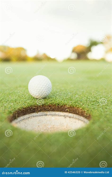 Golf Ball At The Edge Of The Hole Stock Photo Image Of Surface Luck