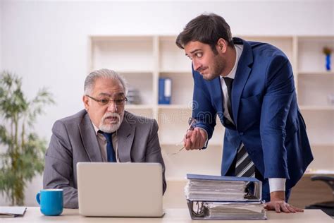 Old Male Boss And Young Male Employee In The Office Stock Photo Image