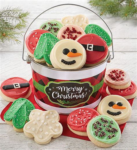 A Bucket Filled With Christmas Cookies Sitting On Top Of A Table