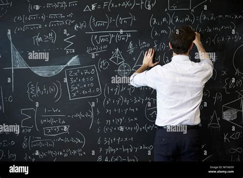 Young Man Writing On Blackboard Stock Photo Alamy