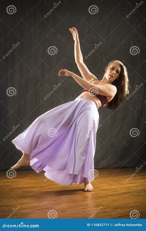 Young Woman Dancing In The Studio On A Hardwood Floor Stock Image