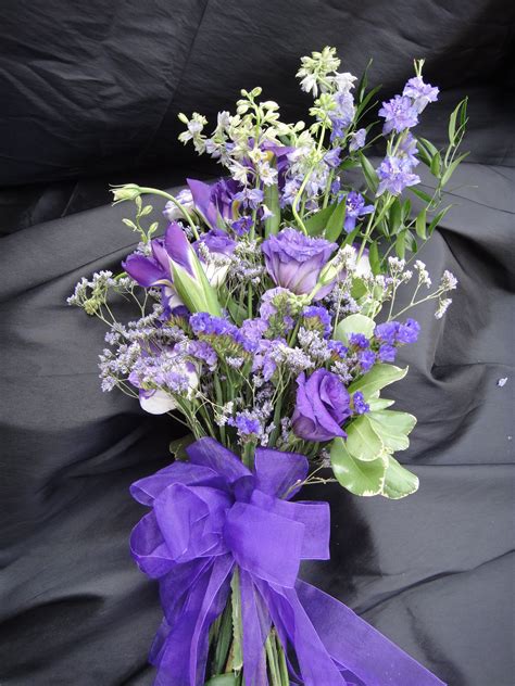 purple bouquet designed using larkspur lisianthus iris caspia and statice custom wedding