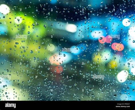 Autumn Rainy Weather View Of Blurred Night City Lights Through The