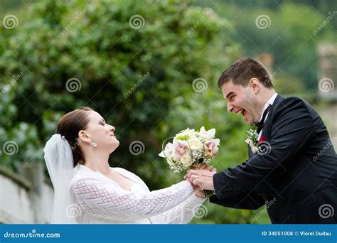 Funny Bride And Groom With Wedding Bouquet Stock Photo Image Of Fight