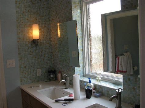 Whether it's glass front entry doors, or interior glass doors the first focal point of an entry into a home, business or office are the doors, and frosted art. Bathroom with a rain-glass window, floating cabinets, and ...