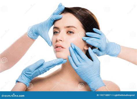 View Of Plastic Surgeons In Blue Latex Gloves Touching Face Of Naked