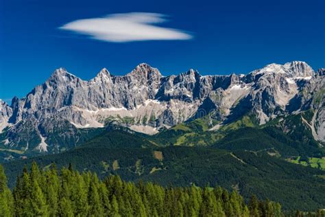 Hohe Dachstein Mountain Range In Austria With Green Trees In The Stock