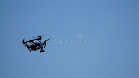 Black Drone Quadcopter With Camera Flying Over Blue Sky Black Drone In
