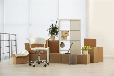 Cardboard Boxes With Packed Stuff In Office Moving Day Stock Photo