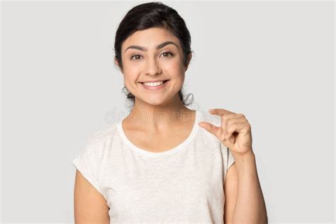 Smiling Satisfied Indian Girl Showing Little Size Gesture With Fingers Stock Image Image Of
