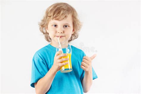 Little Blonde Boy Drinking A Fresh Orange Juice Stock Image Image Of