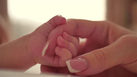 Mother And Her Newborn Baby Parent Holding Newborns Hand Happy Mother