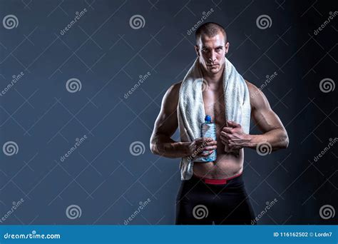 Powerful Man Bodybuilder With Towel And Water After Gym Stock Photo