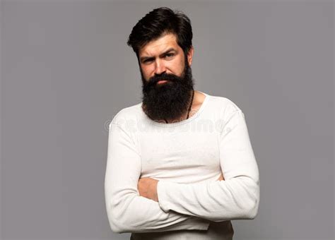 portrait of confident serious man has beard and mustache looks seriously isolated hipster guy