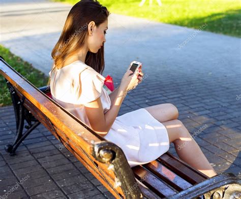 Beautiful Girl Sitting Bench Brunette Pink Dress Fashion Life Style With Your Phone Writes A