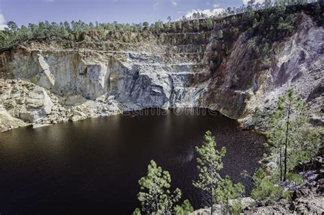 Lake Surrounded By Cliffs And Trees In Minas De Riotinto Spain Stock