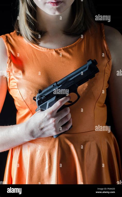Young Woman Holding A Handgun Stock Photo Alamy