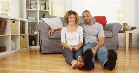 Cute African Couple Sitting On Floor In Living Room Stock Image Image