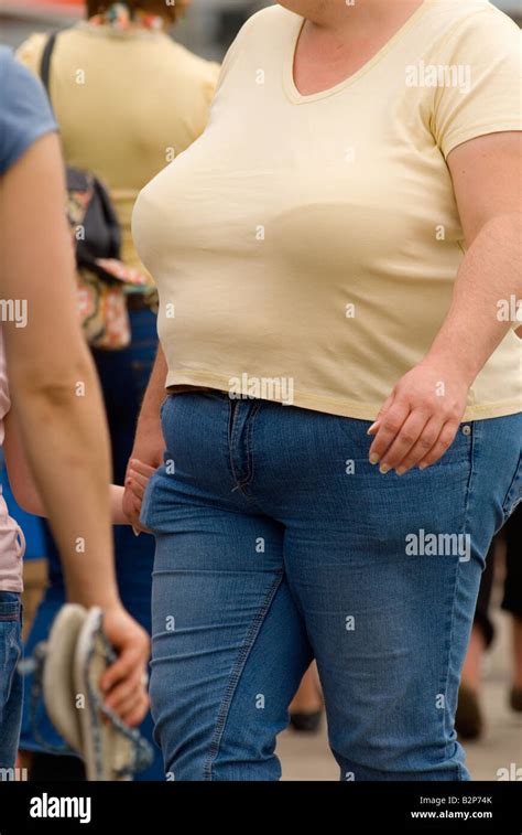 Fat Woman On Holiday Uk Obese Mother Holding Daughters Hand In Crowd Of