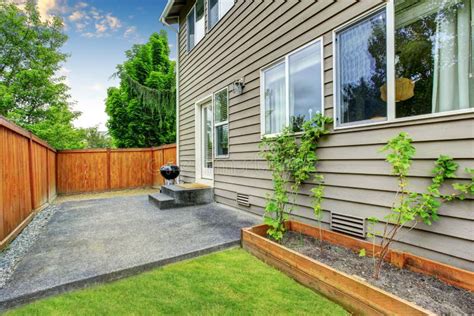 Fenced Backyard Concrete Floor Patio Area And Well Kept Lawn Stock