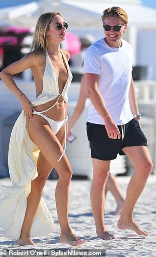 Kimberley Garner Wows In A Racy Plunging Cover Up As She Enjoys Cosy Beach Stroll With Beau