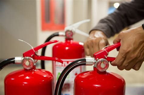 Premium Photo Engineers Pull Out Safety Pin Of Fire Extinguishers