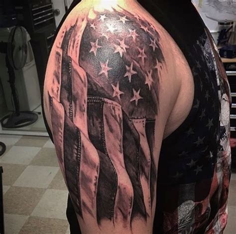 an american flag tattoo on the back of a man s left arm and shoulder