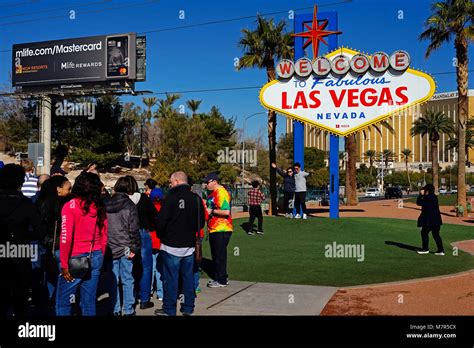Tourists Having Photograph Next To Famous Sign Welcome To Las Vegas