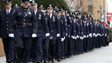 New York City Police Officers March Before Funeral Services For Police