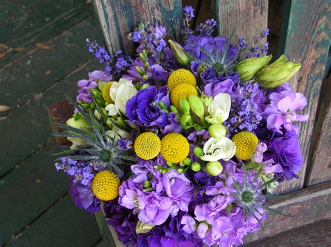 a bouquet of flowers sitting on top of a wooden bench