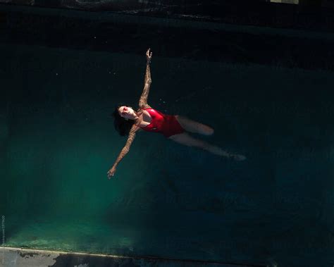 Above View Of Woman Swim On Her Back In The Pool By Stocksy Contributor Nikita Sursin Stocksy