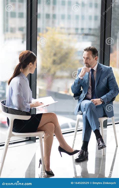 Rich Entrepreneur Enjoying Talk With Young Experienced Journalist Stock