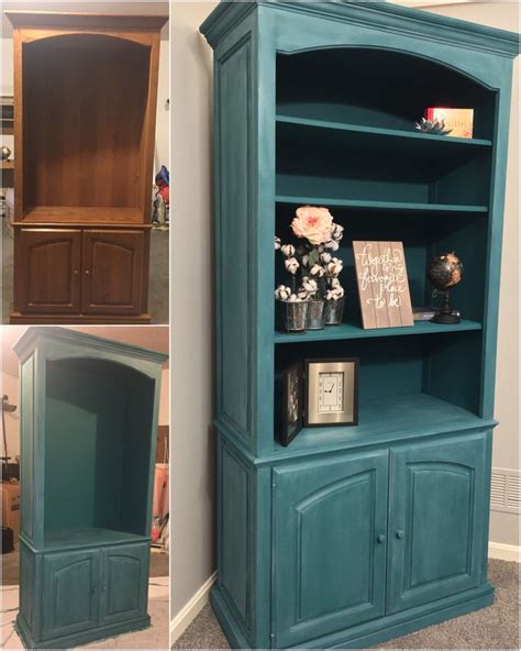 This Bookcase Is Painted Teal And Has Flowers On Top Along With