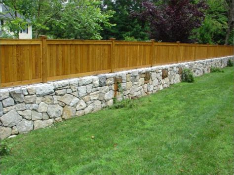 Garden wall natural stone and a bamboo fence. Westchester granite fieldstone retaining wall with cedar ...