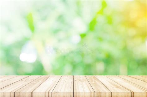 Empty Wooden Table Top With Blurred Green Garden Background Stock