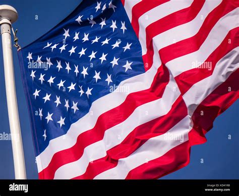 Stars And Stripes American Flag In Close Up Fluttering In Breeze With