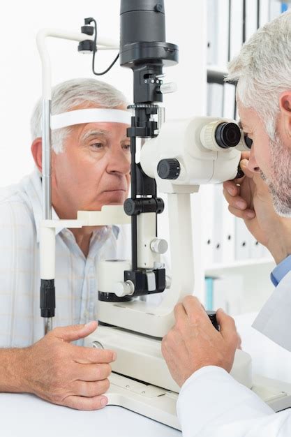 Premium Photo Optometrist Doing Sight Testing For Senior Patient